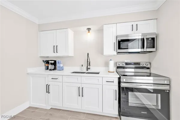 a kitchen with sink and cabinets