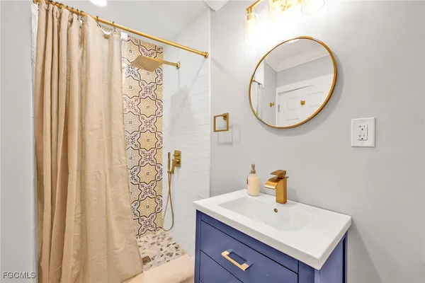 a bathroom with a shower curtain and a shower