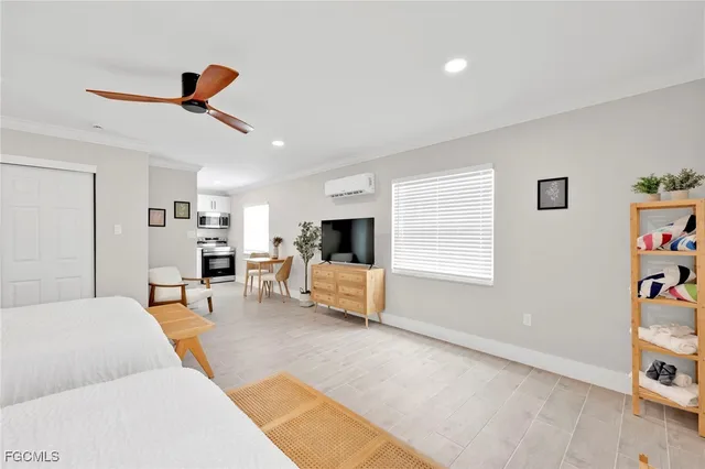a bedroom with two beds and a large window
