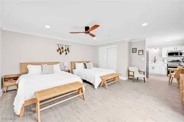 a bedroom with furniture and a large window