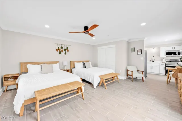 a bedroom with furniture and a large window