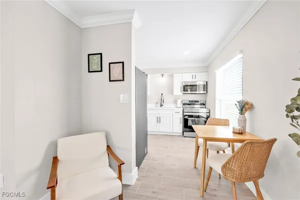 a kitchen with white cabinets and white appliances