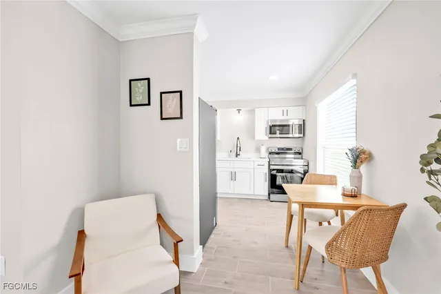 a kitchen with white cabinets and white appliances