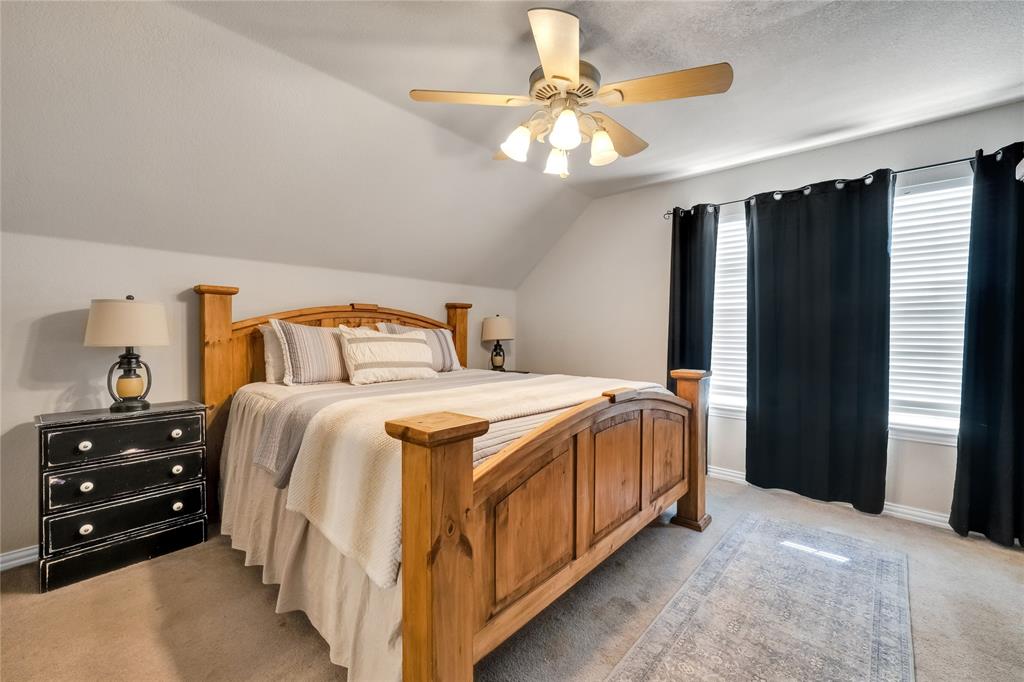 192 County Road 3133 Decatur, TX 76234 - Photo 24 of 35 a bedroom with a bed and a chandelier