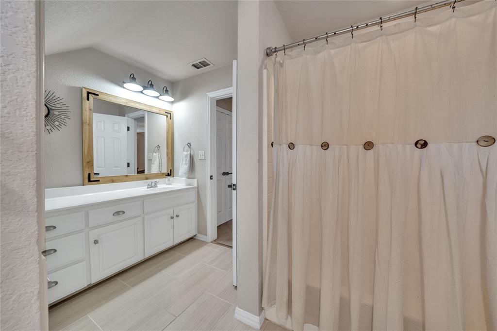 192 County Road 3133 Decatur, TX 76234 - Photo 27 of 35 a spacious bathroom with a double vanity sink mirror and a shower