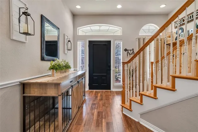 a view of entryway and hall with wooden floor