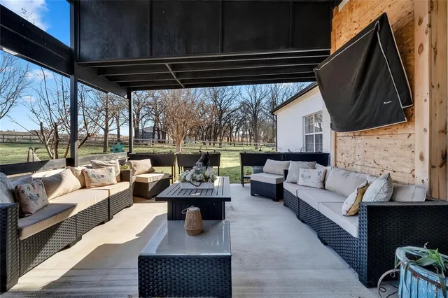 a living room with furniture a fireplace and a table