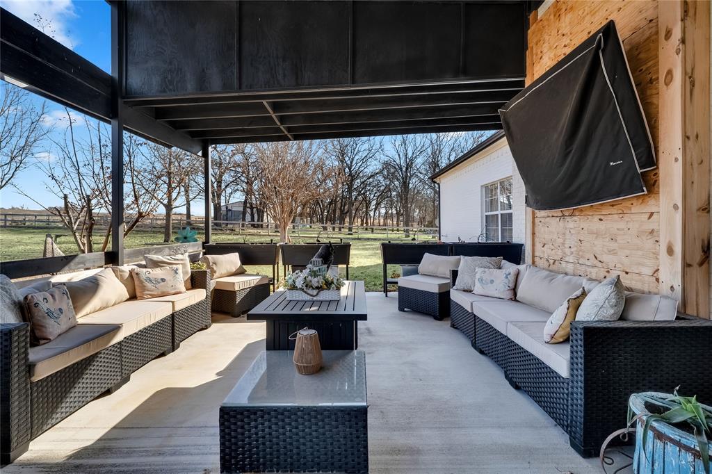 192 County Road 3133 Decatur, TX 76234 - Photo 32 of 35 a living room with furniture a fireplace and a table