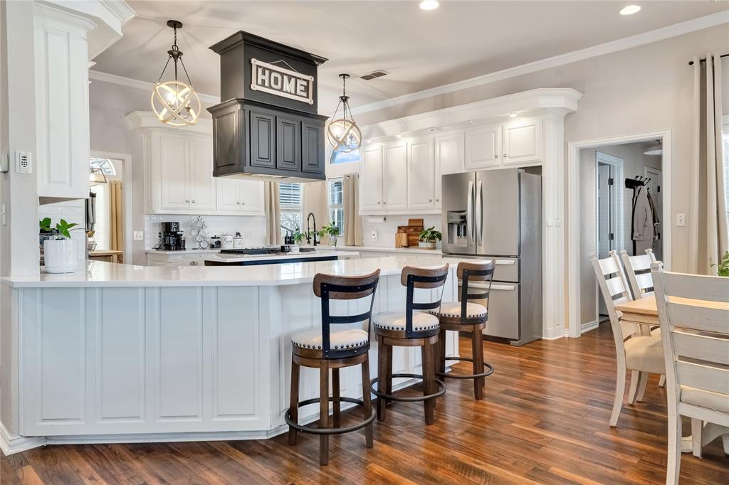 192 County Road 3133 Decatur, TX 76234 - Photo 8 of 35 a kitchen with stainless steel appliances a dining table chairs stove and cabinets