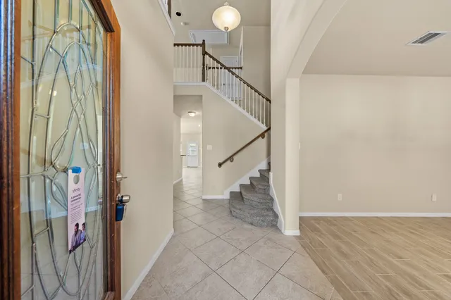 a view of entryway and hall with a front door