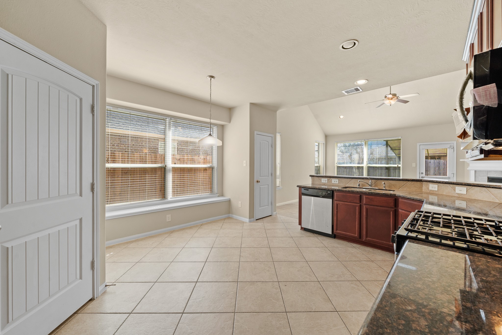 24735 Colonial Maple Drive Katy, TX 77493 - Photo 15 of 32 a large kitchen with a stove a sink dishwasher and a oven