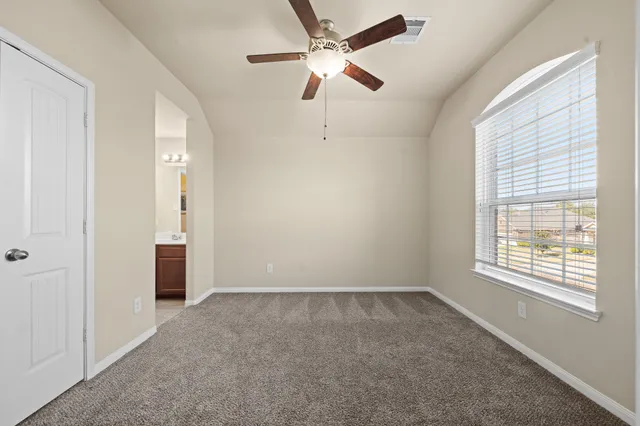 a view of an empty room with a window