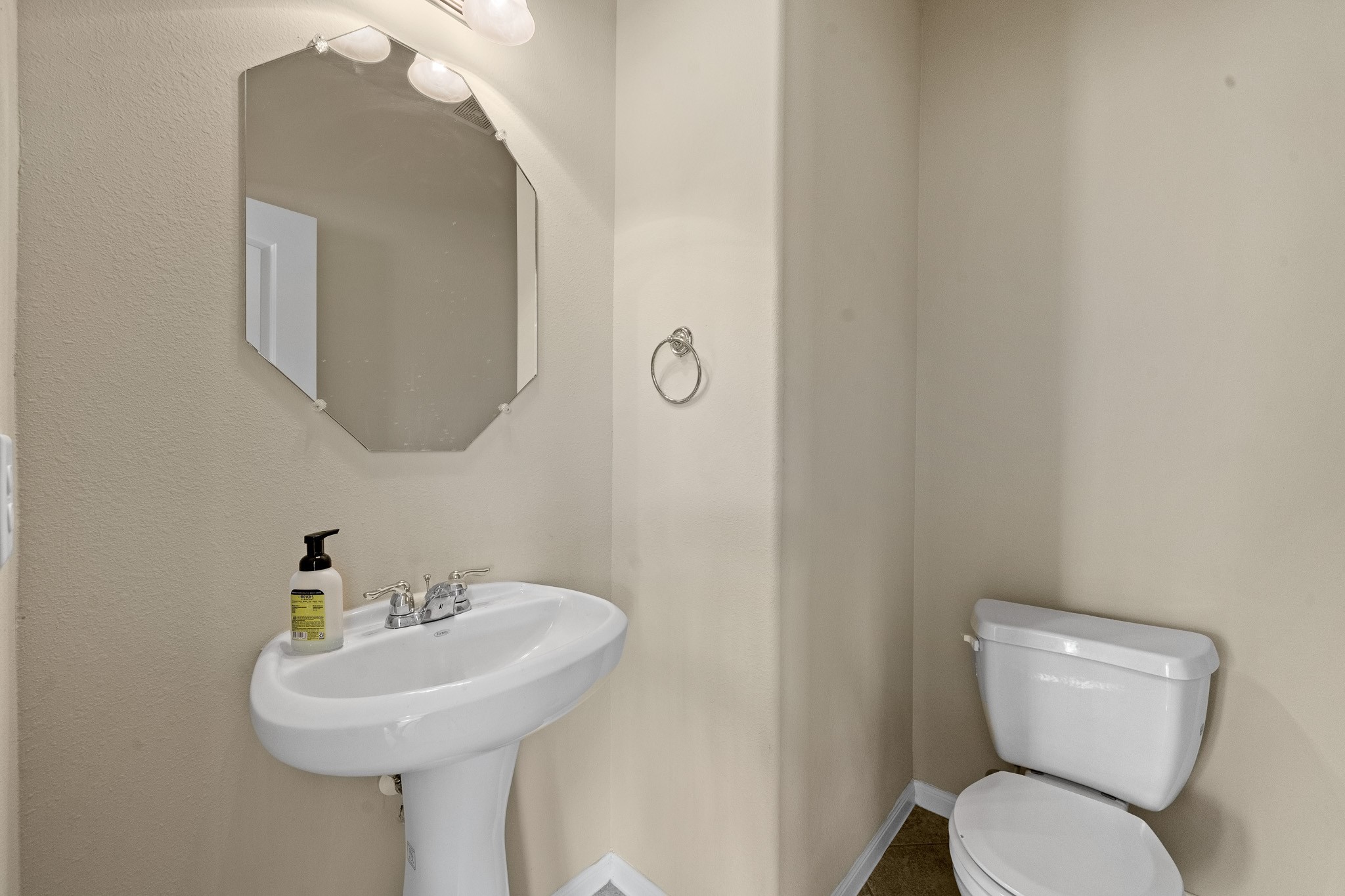 24735 Colonial Maple Drive Katy, TX 77493 - Photo 26 of 32 a bathroom with a toilet sink and mirror