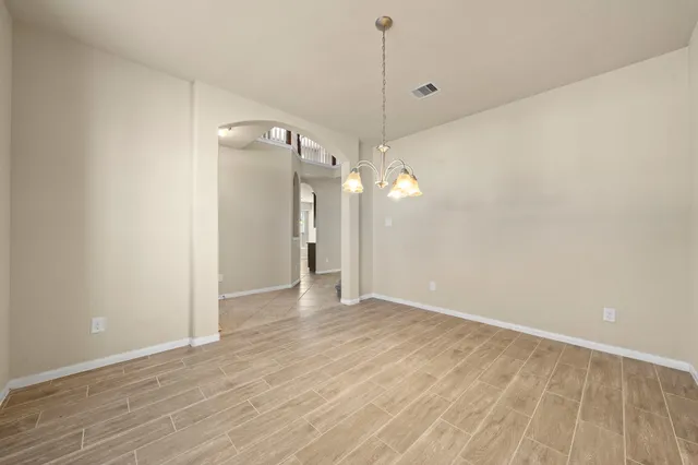 a view of a room with wooden floor