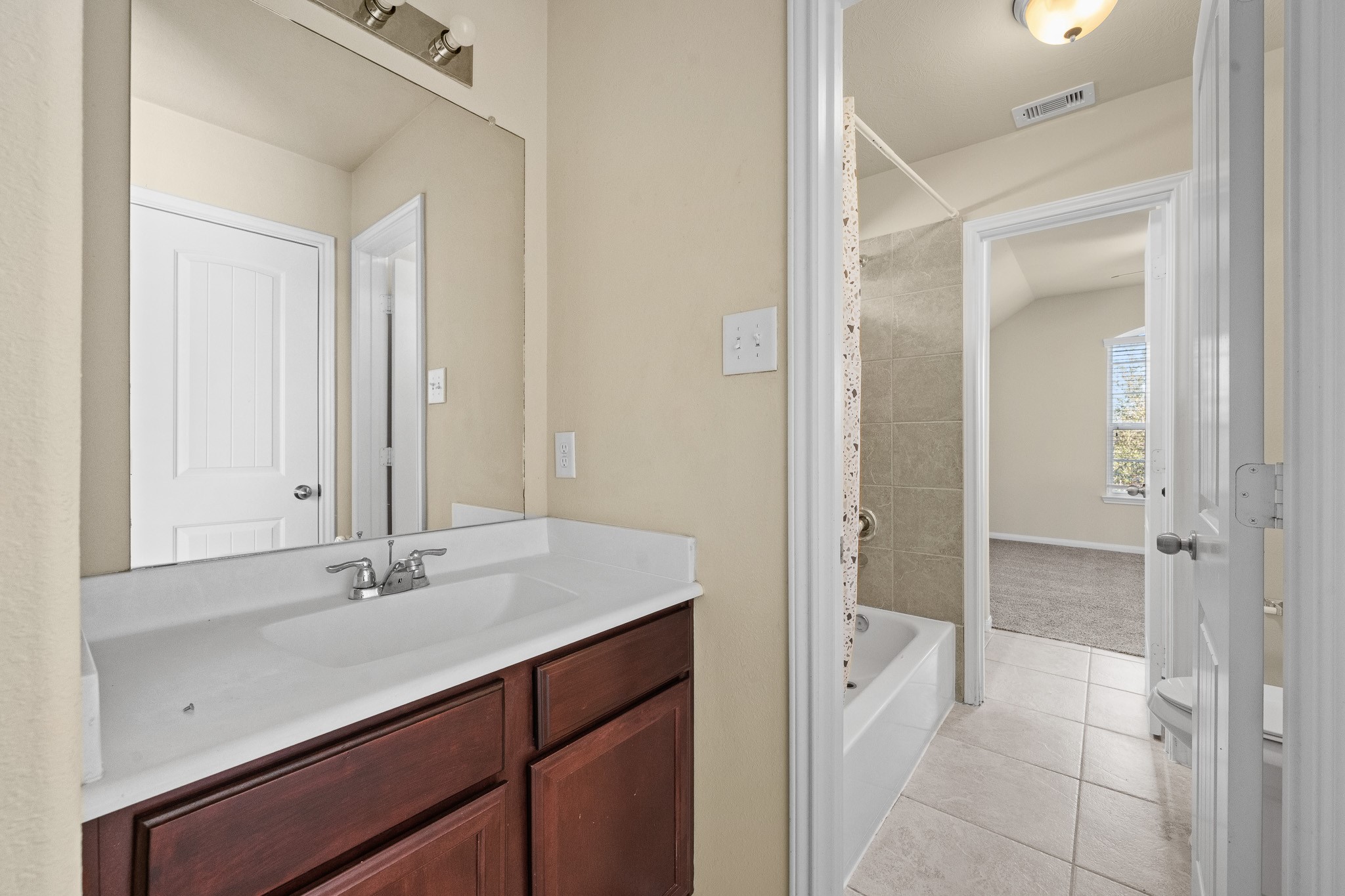 24735 Colonial Maple Drive Katy, TX 77493 - Photo 7 of 32 a bathroom with a sink and a mirror