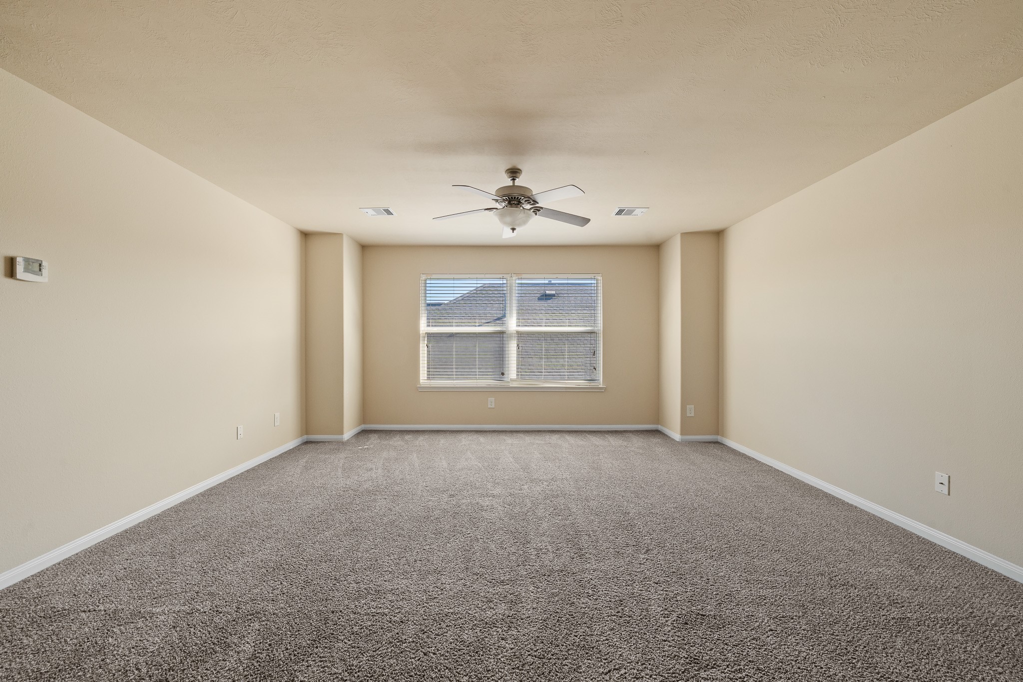 24735 Colonial Maple Drive Katy, TX 77493 - Photo 8 of 32 an empty room with windows and ceiling fan
