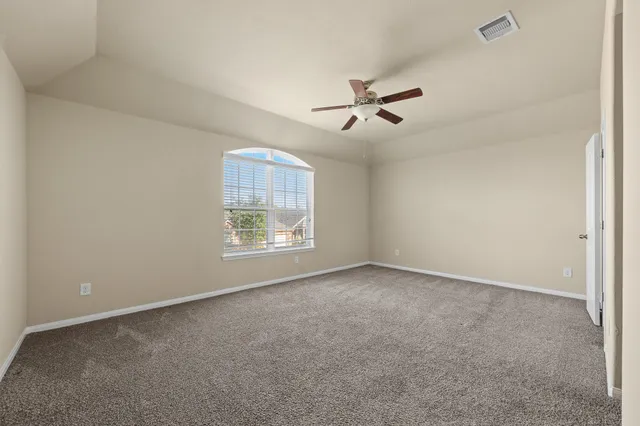 a view of room with a ceiling fan and window