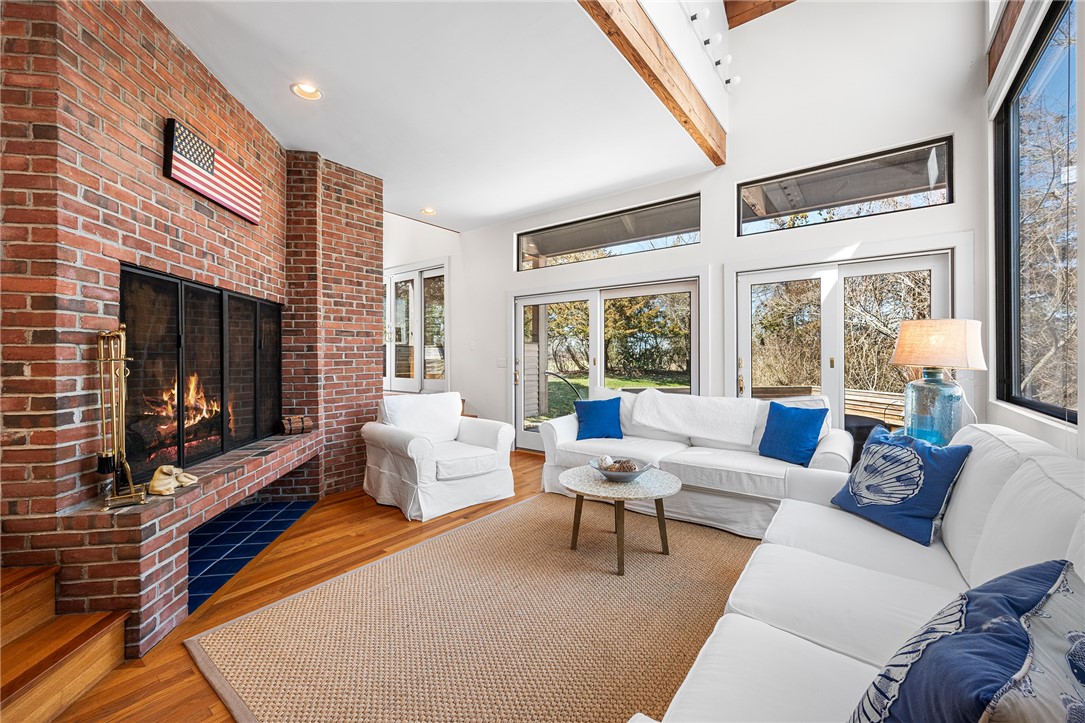 14 Round Hill Road Westerly, RI 02891 - Photo 11 of 35 Cathedral ceilings, cozy brick fireplace with views onto rear deck.