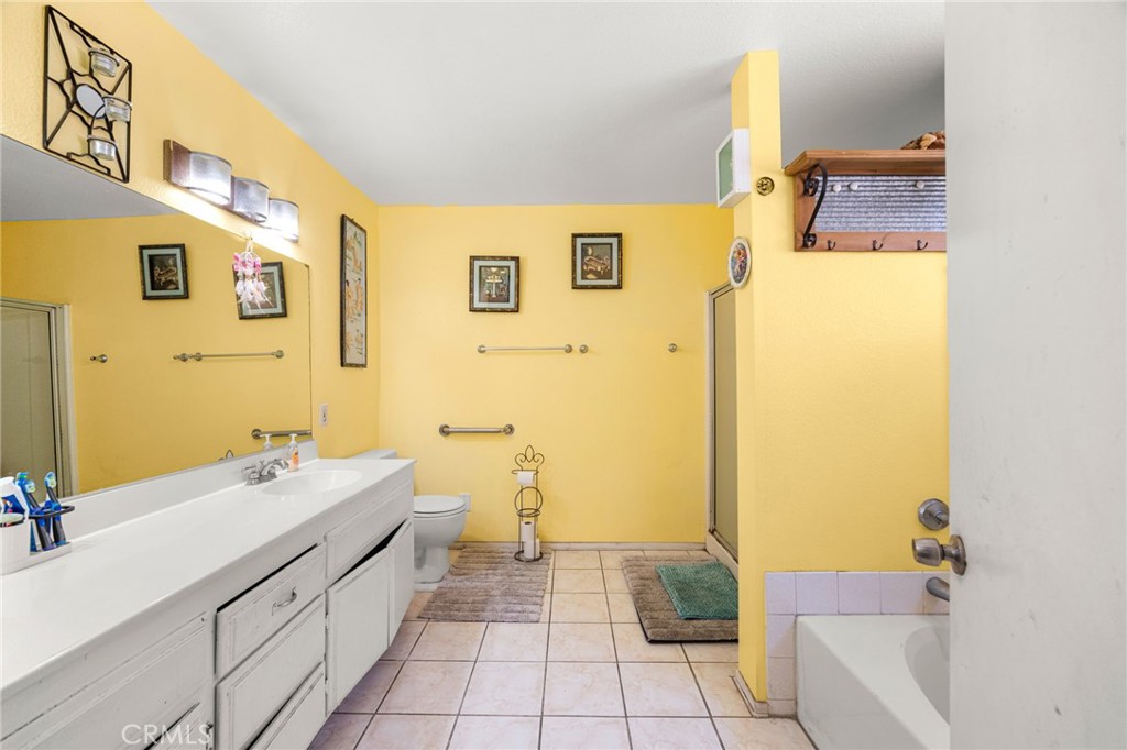 14134 Orizaba Avenue Paramount, CA 90723 - Photo 15 of 24 a bathroom with a sink a toilet and shower