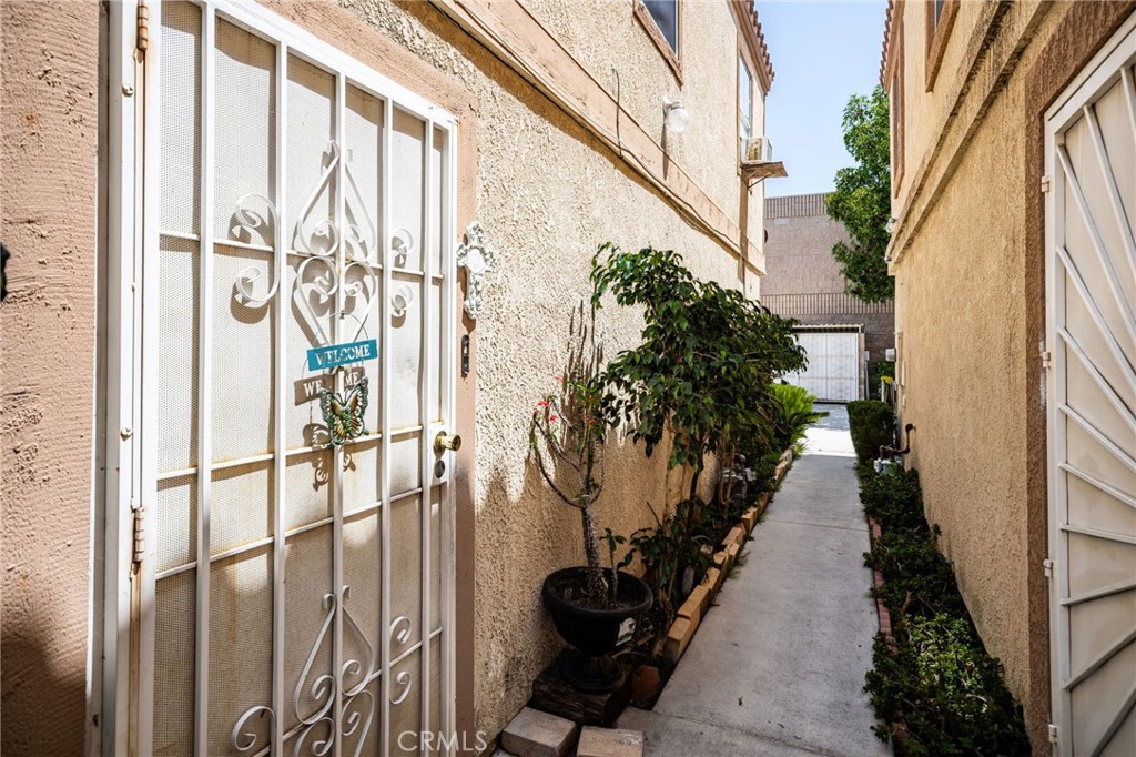 14134 Orizaba Avenue Paramount, CA 90723 - Photo 3 of 24 a view of a pathway of a house with backyard and garden
