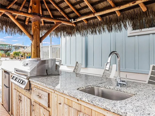 a kitchen with a sink and a stove top oven