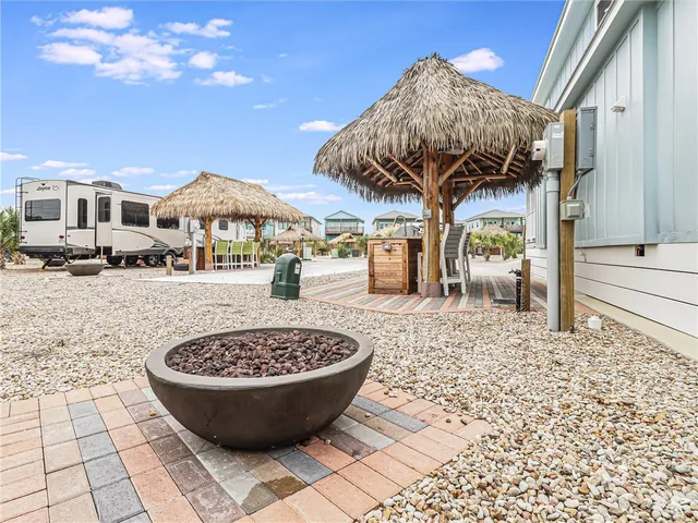 a living room with furniture a flat screen tv and a wooden floor