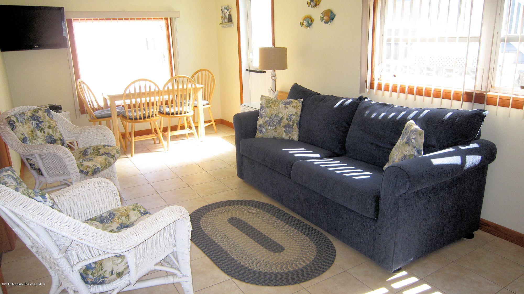 3315 Seaview Road Lavallette, NJ 08735 - Photo 2 of 8 a living room with furniture and a large window