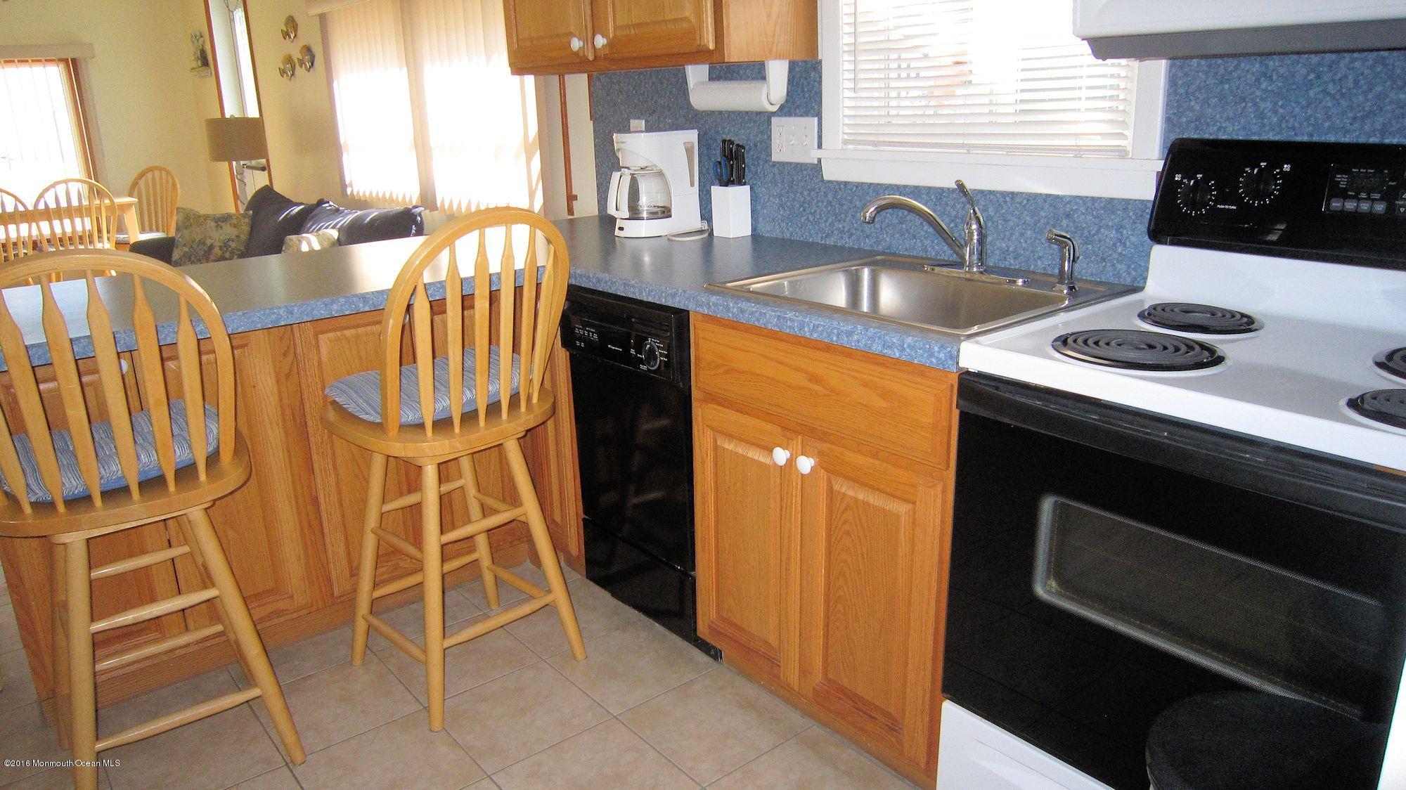3315 Seaview Road Lavallette, NJ 08735 - Photo 4 of 8 a kitchen with granite countertop a sink and a stove