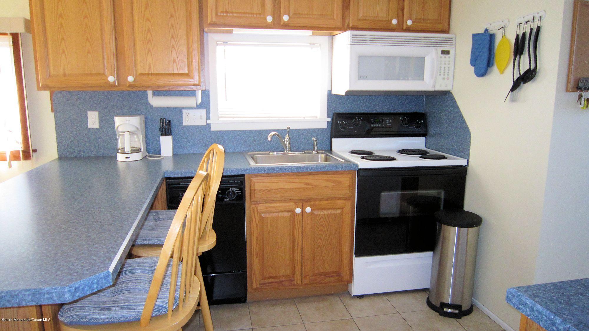 3315 Seaview Road Lavallette, NJ 08735 - Photo 5 of 8 a kitchen with a stove and a refrigerator