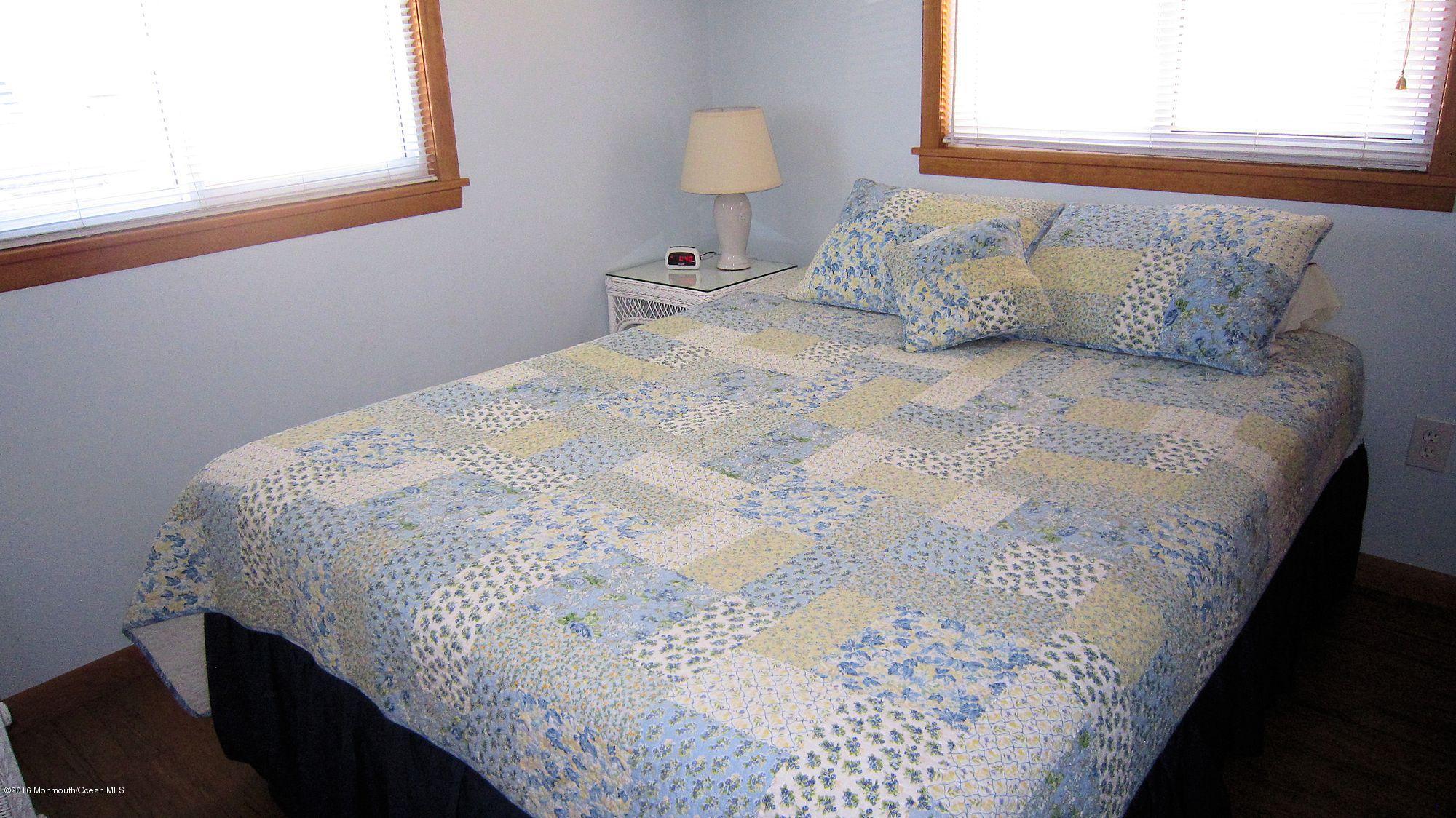 3315 Seaview Road Lavallette, NJ 08735 - Photo 6 of 8 a bedroom with a bed and a window