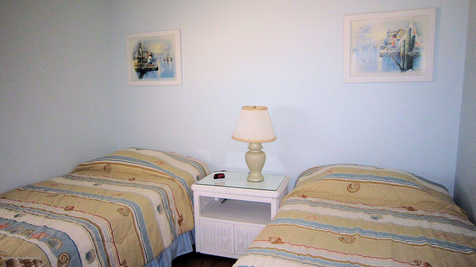 3315 Seaview Road Lavallette, NJ 08735 - Photo 7 of 8 a bedroom with bed and a painting on the wall