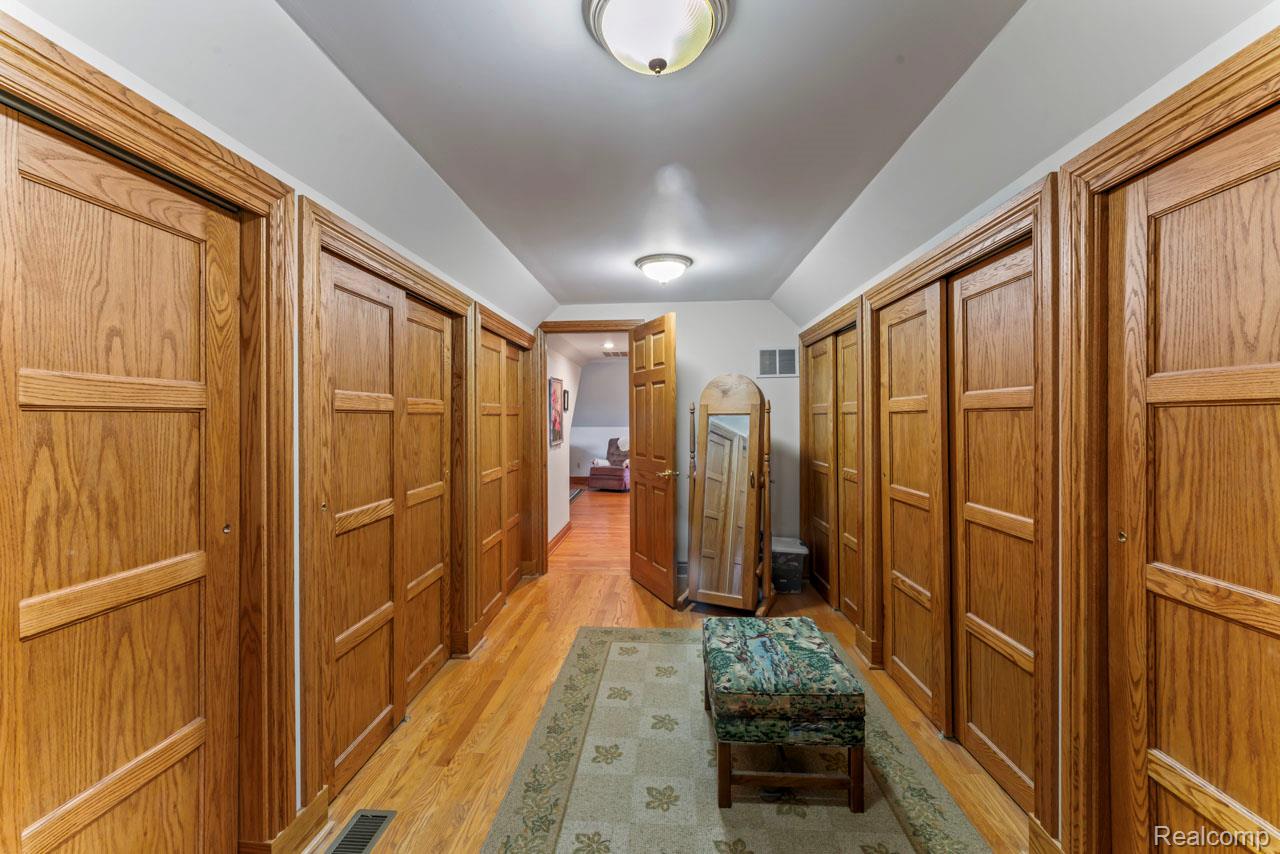 1591 Baldwin Road Lapeer, MI 48446 - Photo 19 of 46 Corridor with lofted ceiling and light wood-style flooring
