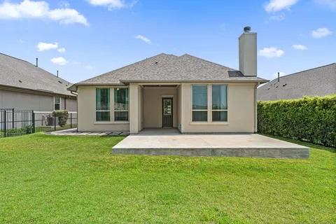 a front view of a house with a garden and yard