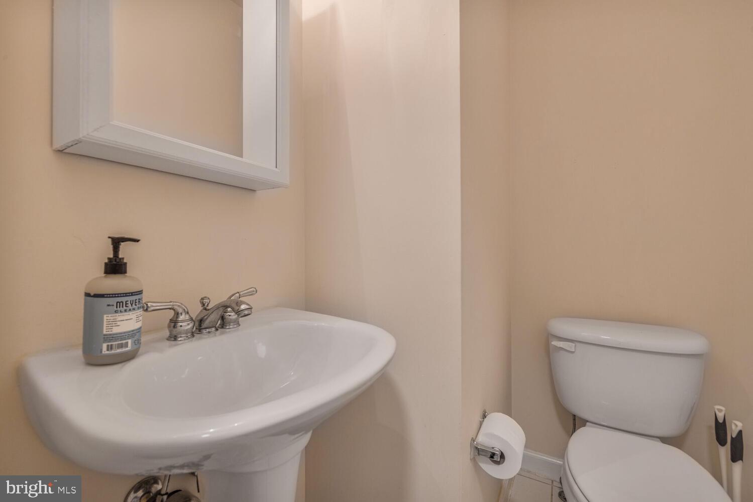 3334 Castle Ridge Circle, Unit 8 Silver Spring, MD 20904 - Photo 11 of 32 a bathroom with a toilet a sink and mirror