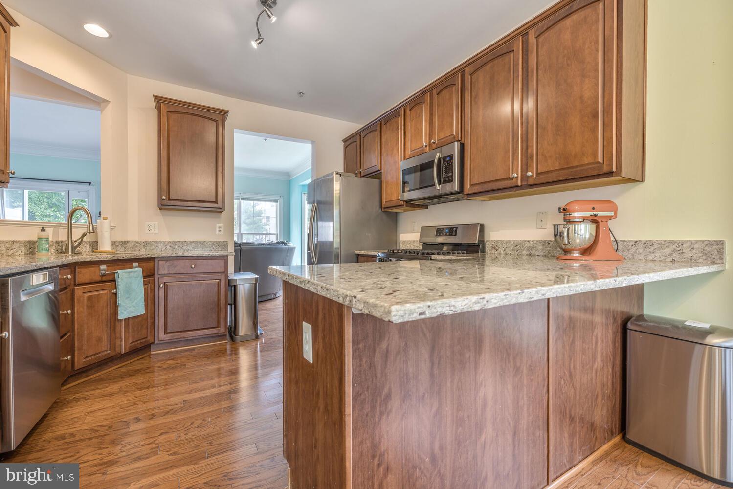 3334 Castle Ridge Circle, Unit 8 Silver Spring, MD 20904 - Photo 2 of 32 a kitchen with stainless steel appliances granite countertop a sink stove and cabinets