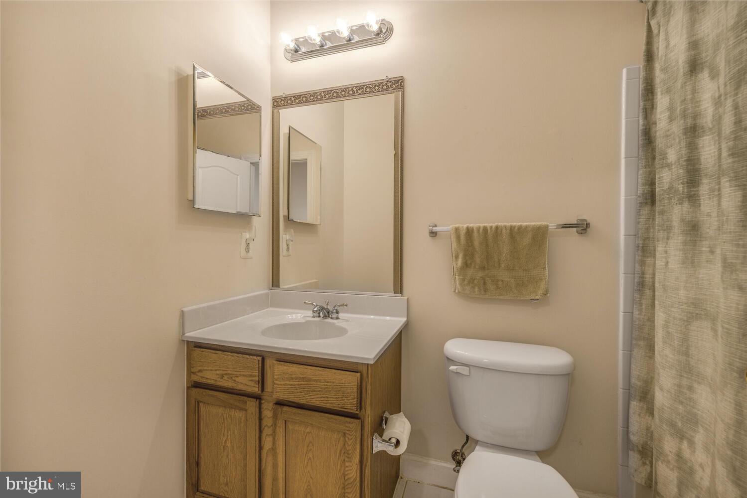 3334 Castle Ridge Circle, Unit 8 Silver Spring, MD 20904 - Photo 21 of 32 a bathroom with a toilet sink and mirror