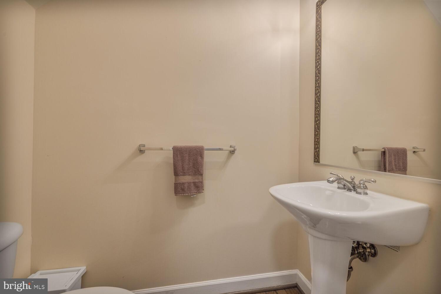 3334 Castle Ridge Circle, Unit 8 Silver Spring, MD 20904 - Photo 23 of 32 a bathroom with a sink a mirror and a toilet