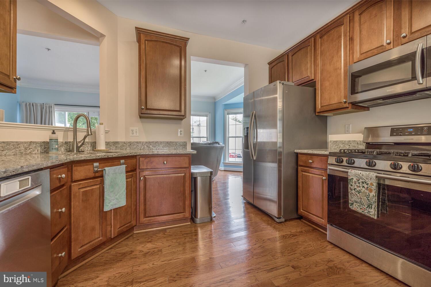 3334 Castle Ridge Circle, Unit 8 Silver Spring, MD 20904 - Photo 3 of 32 a kitchen with stainless steel appliances granite countertop a refrigerator stove and sink