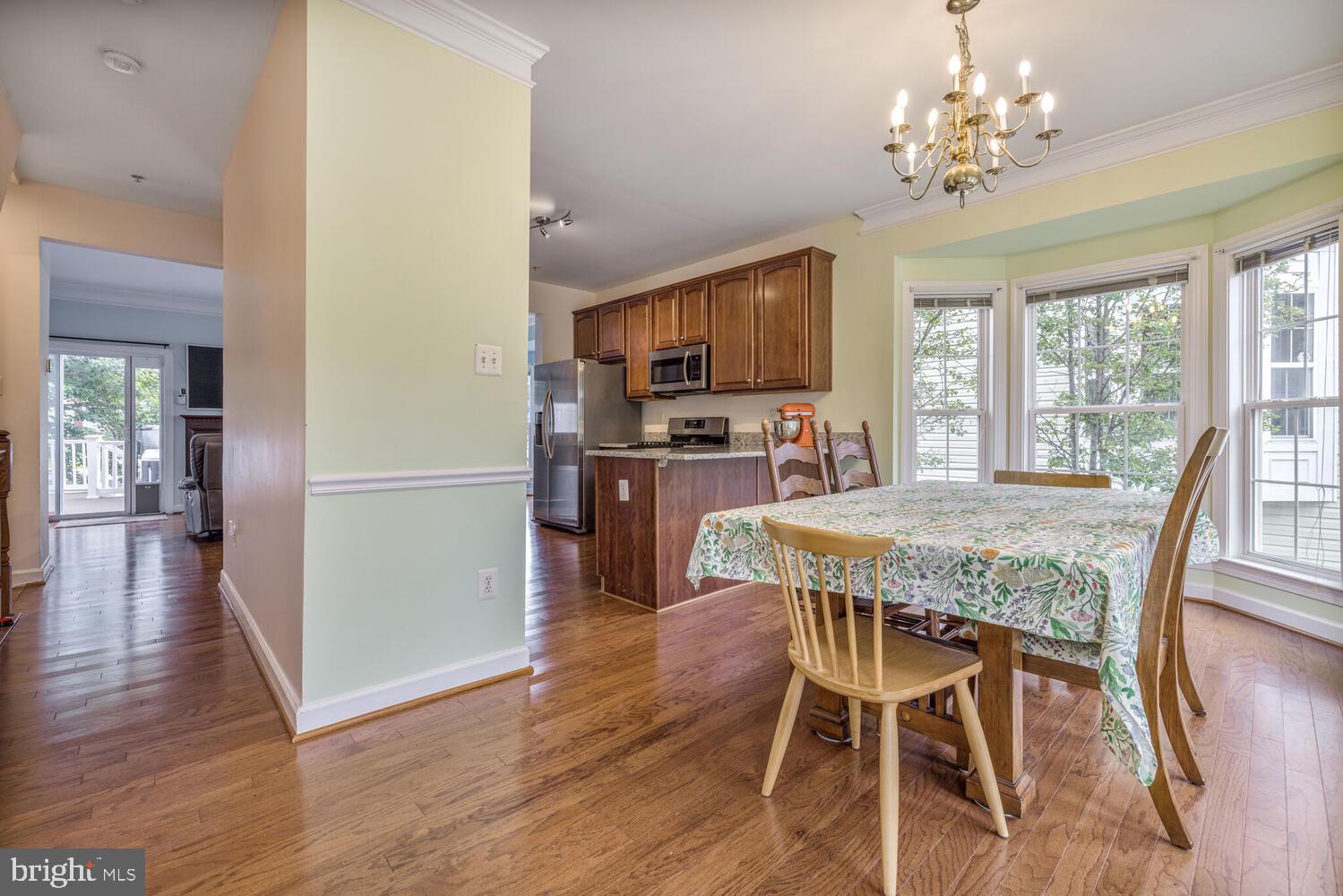 3334 Castle Ridge Circle, Unit 8 Silver Spring, MD 20904 - Photo 8 of 32 a dining room with furniture a chandelier and wooden floor