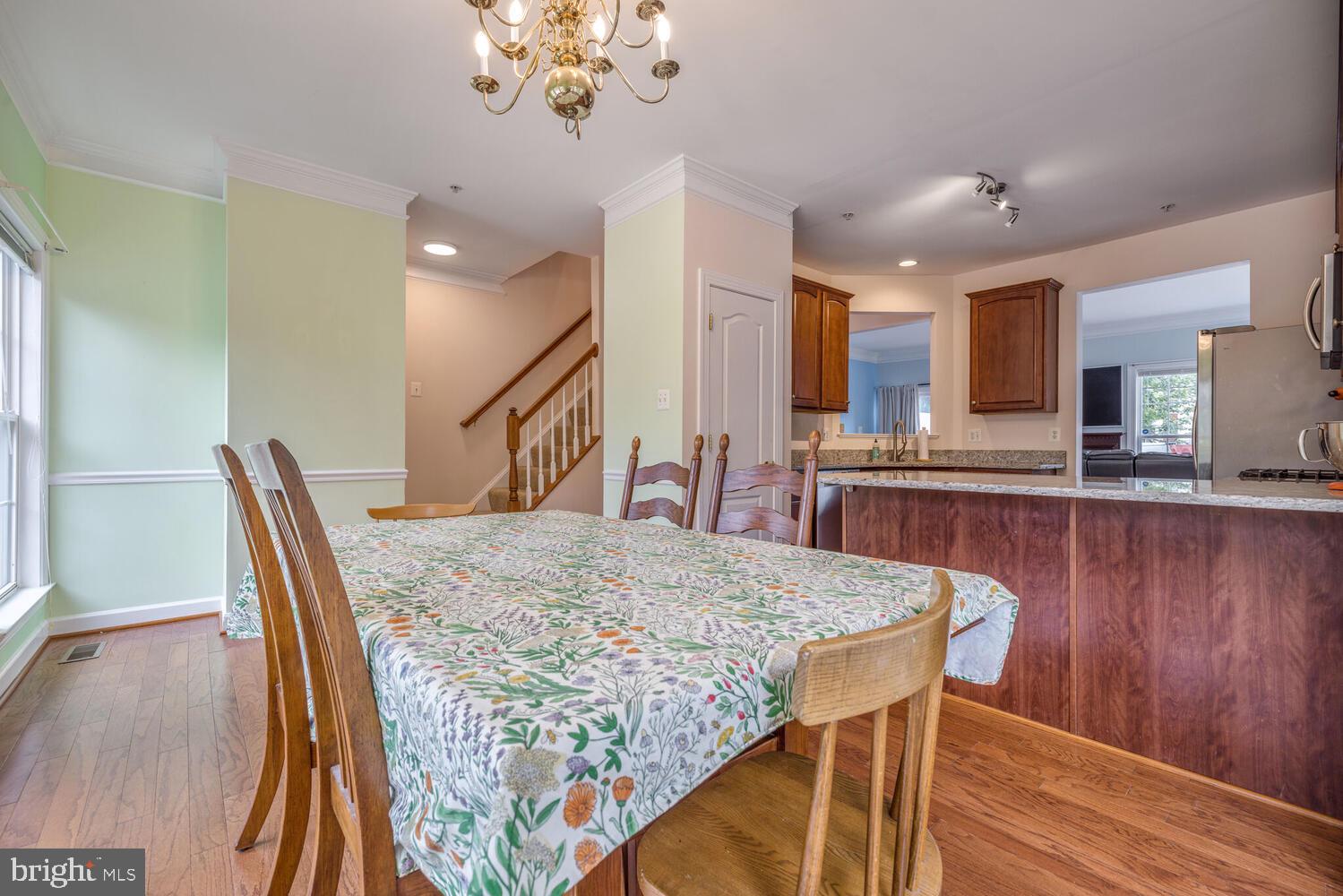 3334 Castle Ridge Circle, Unit 8 Silver Spring, MD 20904 - Photo 9 of 32 a view of a dining room with furniture and wooden floor