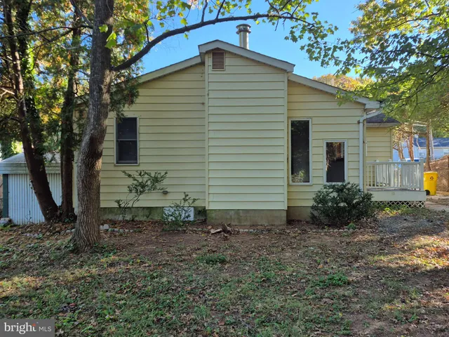 a view of a house with a yard and potted plants