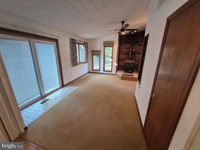 a view of a hallway to rooms and stairs