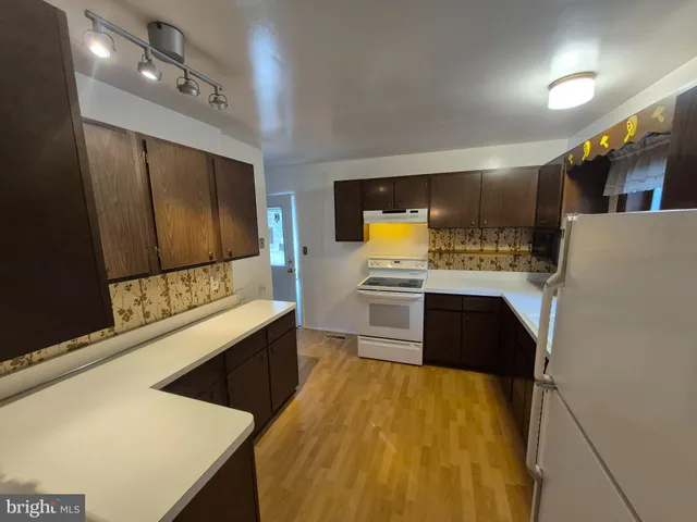 a kitchen with a sink and a stove top oven