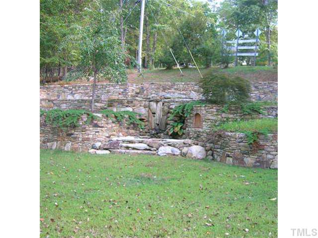 1202 Trail End Road Durham, NC 27712 - Photo 2 of 18 Side with custom stone wall/fountain