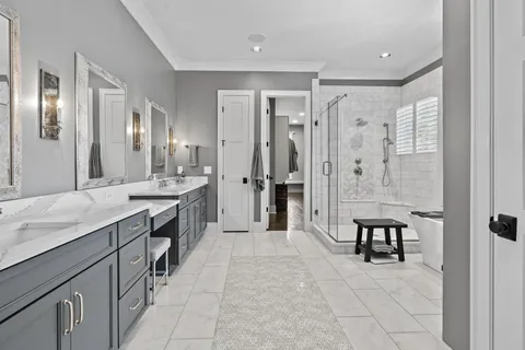 a large bathroom with a granite countertop sink a toilet a mirror and shower