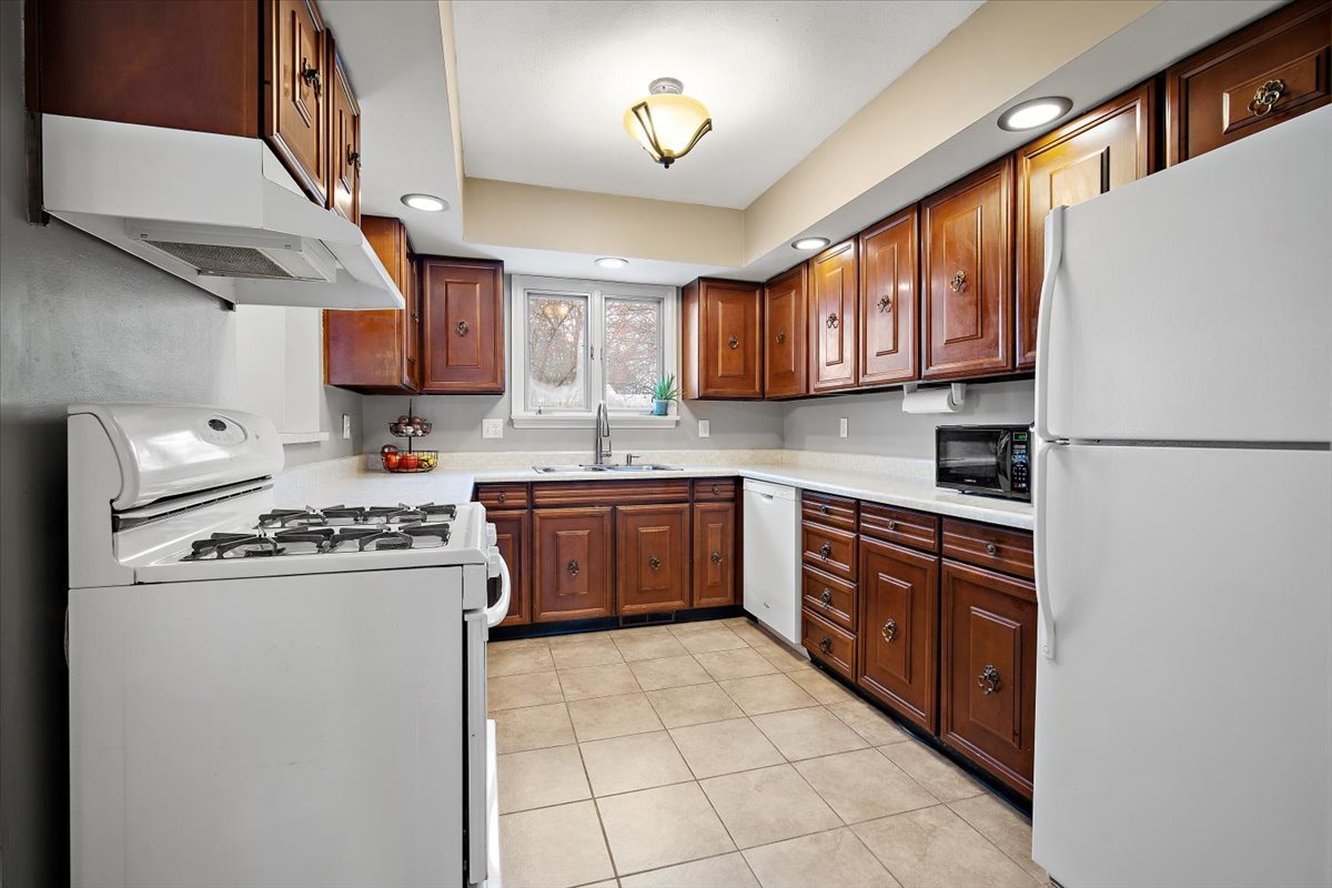 203 South Cottage Avenue Normal, IL 61761 - Photo 11 of 25 a kitchen with stainless steel appliances granite countertop a stove sink and a refrigerator