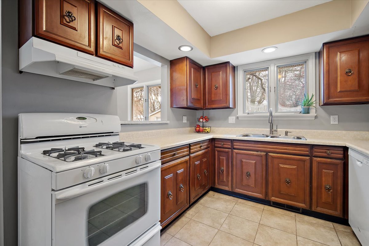 203 South Cottage Avenue Normal, IL 61761 - Photo 12 of 25 a kitchen with stainless steel appliances granite countertop a stove sink and cabinets