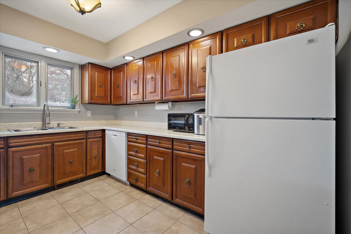 203 South Cottage Avenue Normal, IL 61761 - Photo 13 of 25 a kitchen with stainless steel appliances granite countertop a refrigerator sink and cabinets