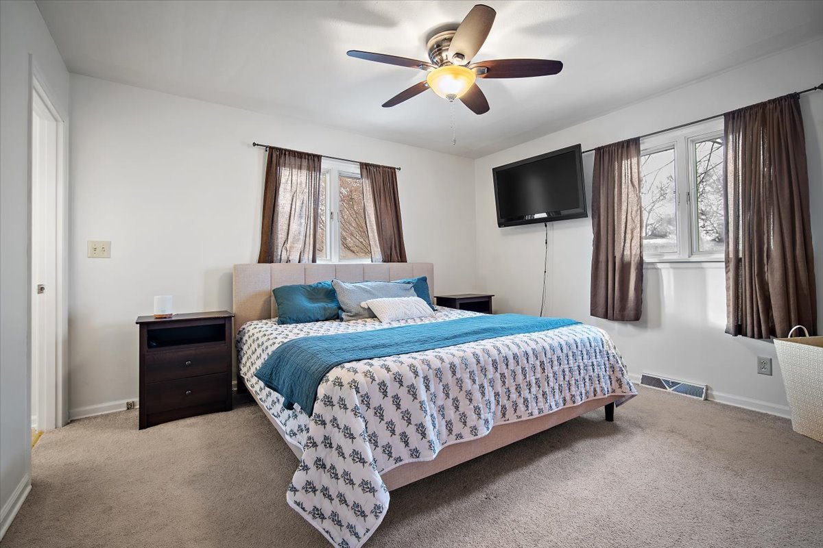 203 South Cottage Avenue Normal, IL 61761 - Photo 17 of 25 a bedroom with a bed and a flat screen tv