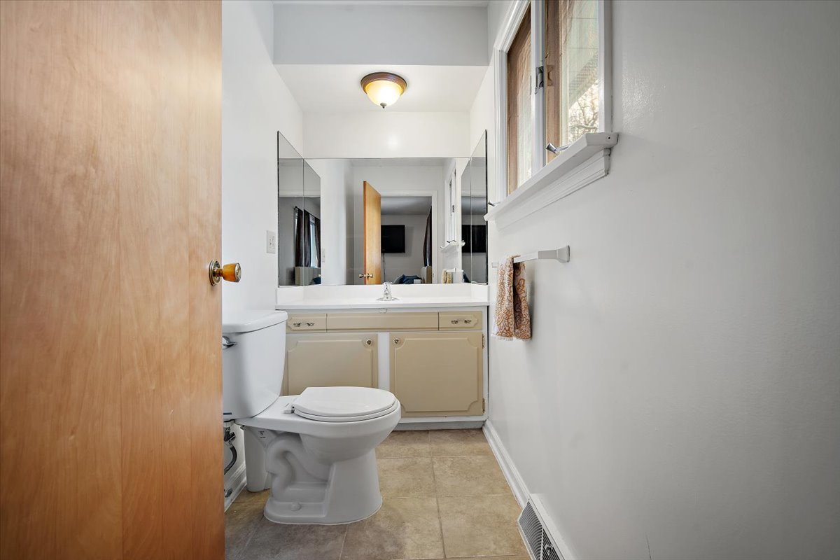 203 South Cottage Avenue Normal, IL 61761 - Photo 18 of 25 a bathroom with a sink toilet and mirror